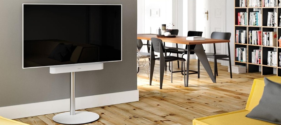 Téléviseur blanc sur un stands blanc avec une barre de son blanche dans le salon.